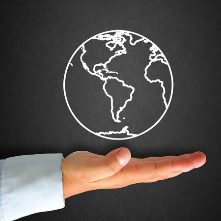 World map in blackboard with handの写真素材