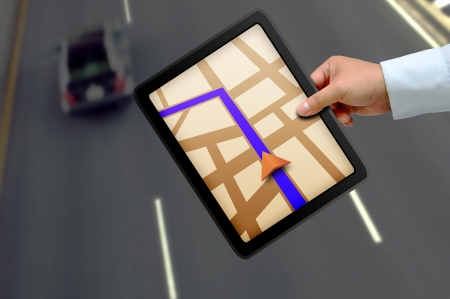 Male hand holding a touchpad gpsの写真素材