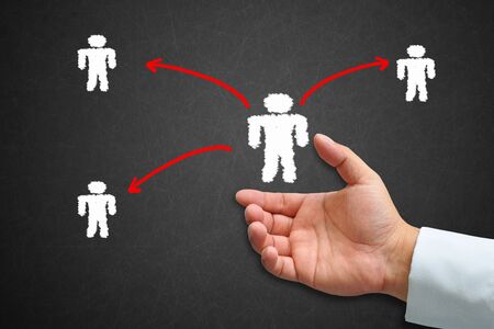 Human hand with human icon and drawing social network on a blackboardの写真素材