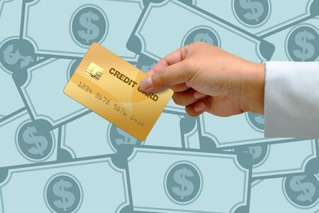 Hand holding credit card with Many money backgroundの写真素材
