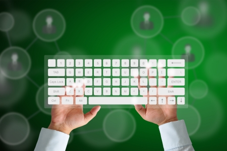Hand on Keyboard with human icon button and social network backgroundの写真素材