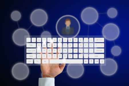 Hand on Keyboard with human icon button and social network backgroundの写真素材