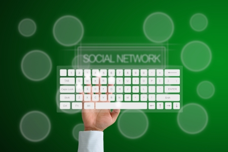 Hand on Keyboard with human icon button and social network backgroundの写真素材