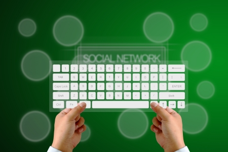 Hand on Keyboard with human icon button and social network backgroundの写真素材