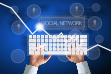 Hand on Keyboard with human icon button and social network backgroundの写真素材