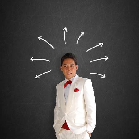 man in a white tuxedo on Blackboard with Business graphの写真素材