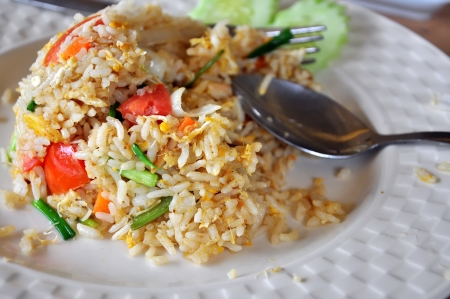 Fried rice with eggs and spoon and forkの写真素材