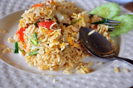 Fried rice with eggs and spoon and forkの写真素材