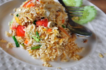 Fried rice with eggs and spoon and forkの写真素材