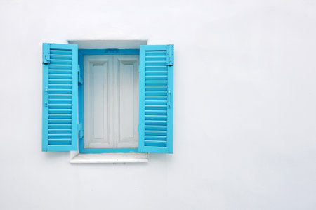 Blue window on white wallの写真素材