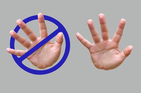 Hand of making stop gesture on gray backgroundの写真素材