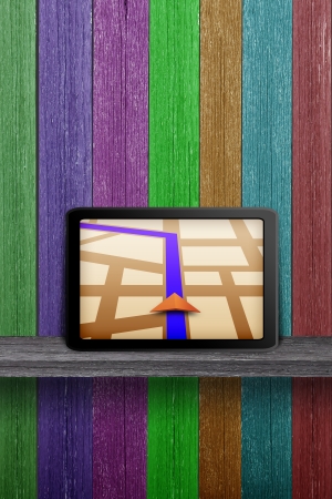 Touchpad gps on the wood shelf and wood wallの写真素材