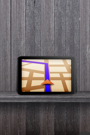 Touchpad gps on the wood shelf and wood wallの写真素材