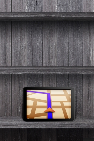 Touchpad gps on the wood shelf and wood wallの写真素材