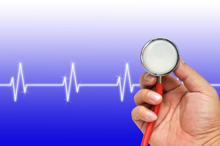 Stethoscope in hand with heart beats cardiogramの写真素材