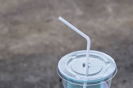 White drinking straw on the disposable plastic cupの写真素材