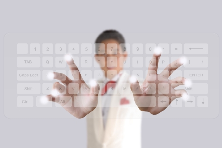 Businessman hand pushing button on a touch screen computer keyboardの写真素材