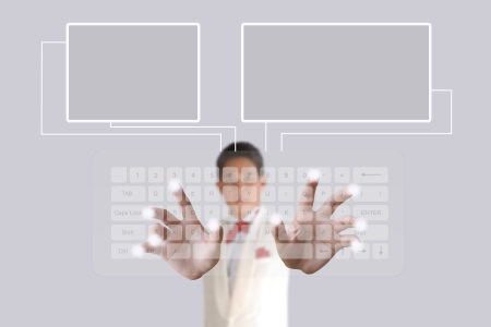 Businessman hand pushing button on a touch screen computer keyboardの写真素材