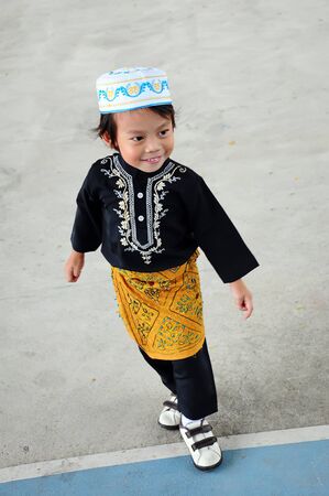 Portrait of asian boy with smile in malaysia dressの写真素材