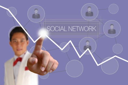 Businessman pushing Social Network button on the blue backgroundの写真素材
