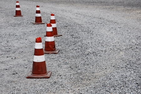 Old Traffic cone used in gravel streetの写真素材