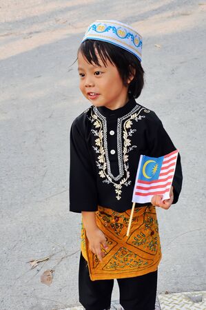 Young boy holding a flag of Malaysiaの写真素材