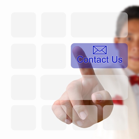Contact us button on keyboard with finger pushing a buttonの写真素材