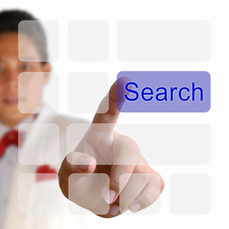 Search button on keyboard with finger pushing a buttonの写真素材