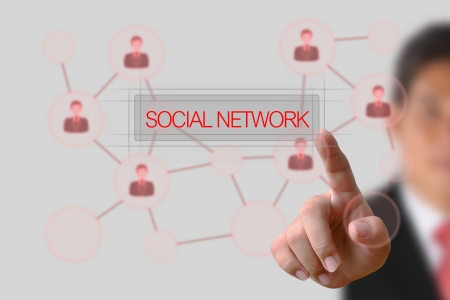 Businessman pushing Social Network button on the white backgroundの写真素材