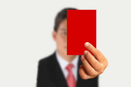 Businessman in suit showing red paper on white backgroundの写真素材