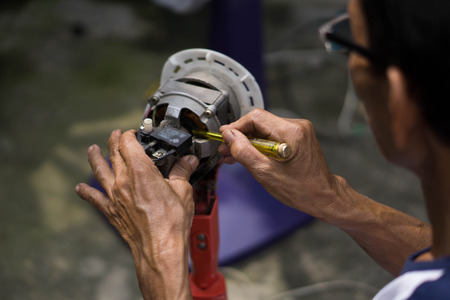 Man repairing a fanの写真素材