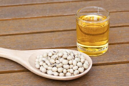 Soy oil with soy bean on a tableの写真素材