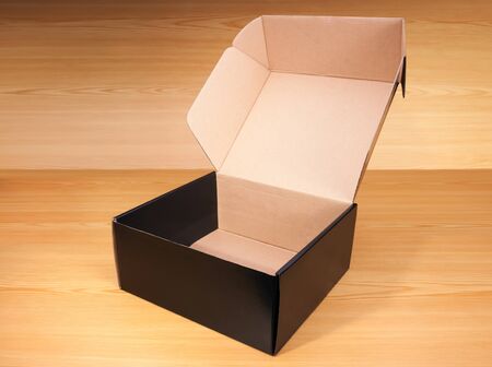 Open blank black box mock up on wood background.