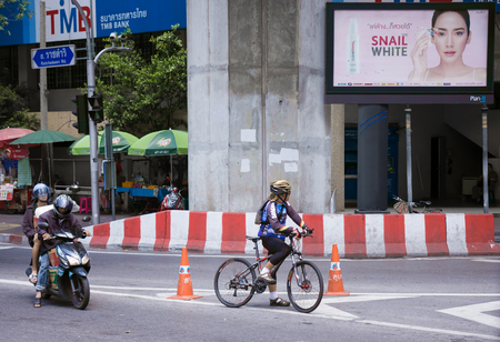 Bangkok, Thailand - July 11, 2015: Bicyclist standing with bicycle waits for green traffic light at Ratchaprasong Junction ,Cycling is gaining popularity in Thailandのeditorial素材