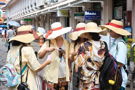 Bangkok, Thailand - June 9, 2015: A group of young female tourists buy the tickets for visiting Grand Palace-- is the top tourist attractions in Bangkokのeditorial素材