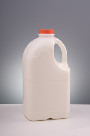 Plastic milk gallon, isolated on gray background with clipping pathの写真素材