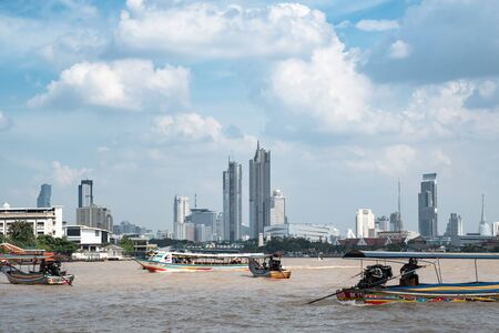 Bangkok, Thailand - September 7, 2018: Cityscape on Chao Phraya River, Tourist boats on Chao Phraya River with high rise buildings in backgroundのeditorial素材