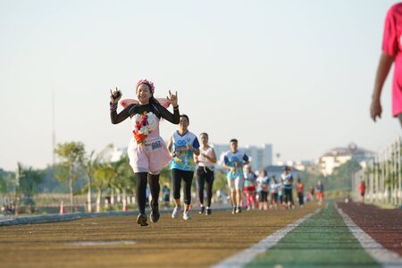 Khonkaen, Thailand - December 23, 2018: Female runner showing hand gestures before running through the finish line during the Khonkaen Mini Marathon at Thungsang Health Parkのeditorial素材