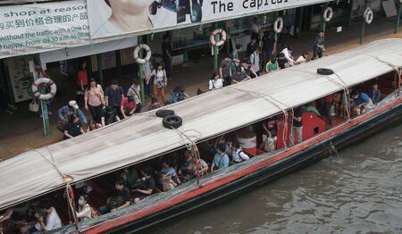 Bangkok, Thailand - September 14, 2018: Passengers get in a ferry boat at Pratunam Pier, The Saen...