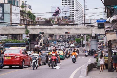 Bangkok, Thailand - September 14, 2018: Moto Taxi with passenger driving on Ratchadamri Rd. during rush hour in the evening. Motorbike is the most fastest vehicles to travel in Bangkokのeditorial素材