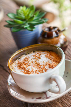 Cup of hot coffee on a wooden table.の写真素材