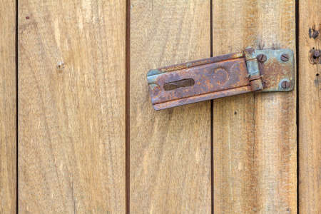 Rusty hinge Lock on old wooden door.の写真素材