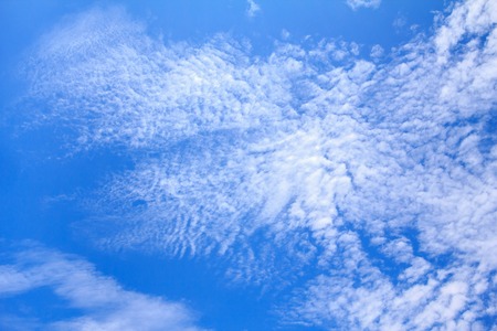 Blue sky background with white clouds. The vast blue sky and clouds sky on sunny day. White fluffy...
