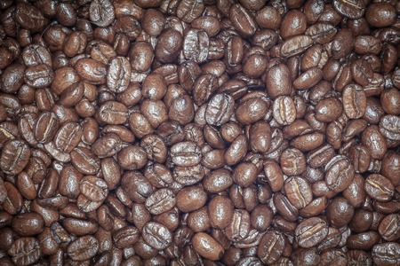Coffee beans closeup. Roasted brown coffee beans texture or coffee beans background for design.