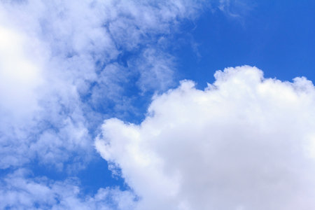 Blue sky background with white clouds. The vast blue sky and clouds sky on sunny day. White fluffy clouds in the blue sky.の写真素材
