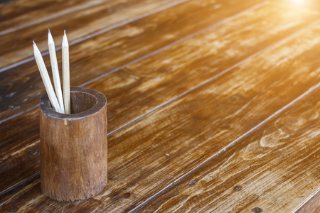 Pencil in bamboo on wood table with sunlight background  for business, education and communication concept design.の写真素材