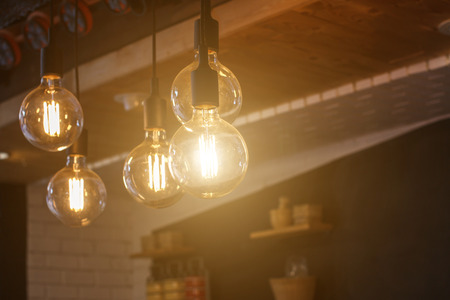 Decorative antique style filament LED light bulbs in restaurant for electricity or technology concept design.の写真素材