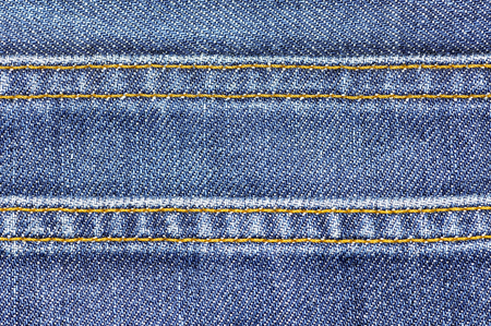 Denim jeans fabric texture background with seam for beauty, fashion and clothing idea concept...