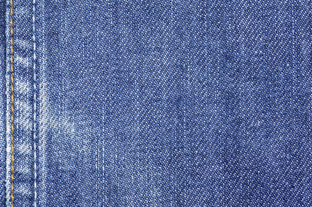Denim jeans fabric texture background with seam for beauty clothing, fashion business design and...