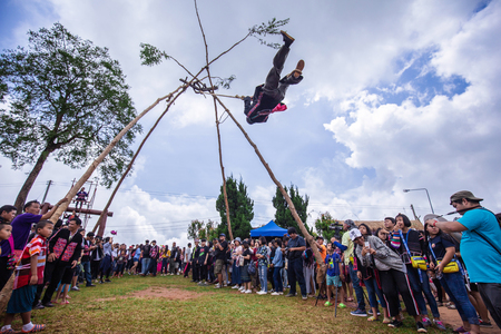 Doi Mae Salong, Chiang Rai - THAILAND, September 8, 2018 : Akha tribe playing with the wooden swing on Akha Swing Festival. The annual Akha Swing Festival is pretty much about women and fertility.のeditorial素材